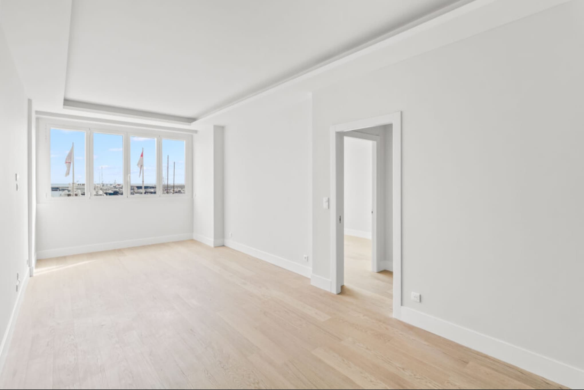 Séjour spacieux et lumineux dans un appartement à vendre à Monaco, offrant confort et élégance avec vue sur le port.